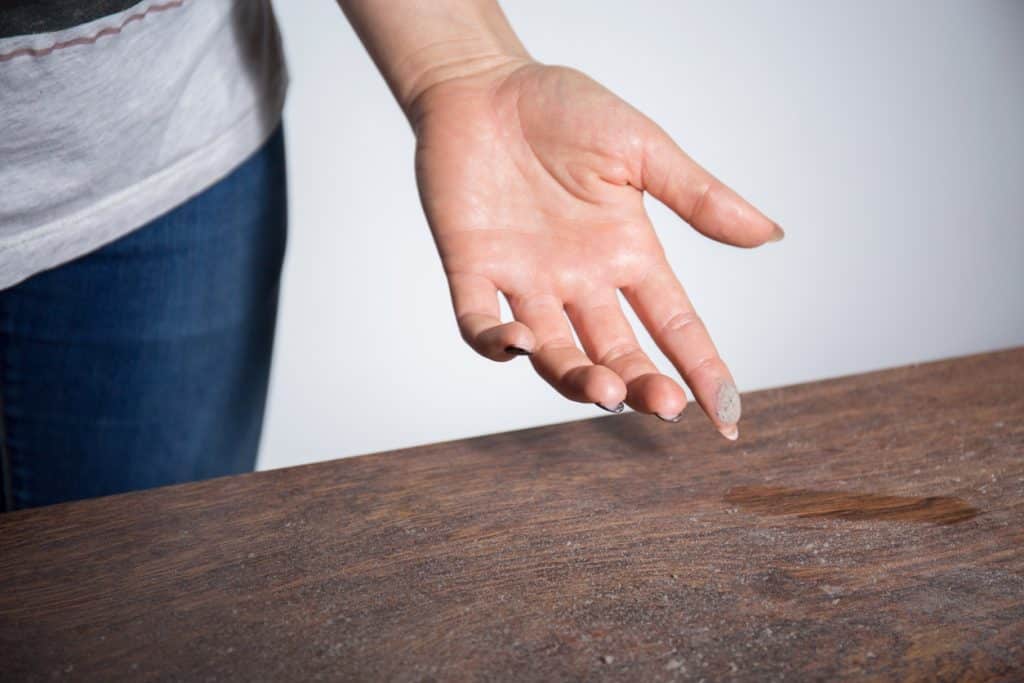 dust on woman finger